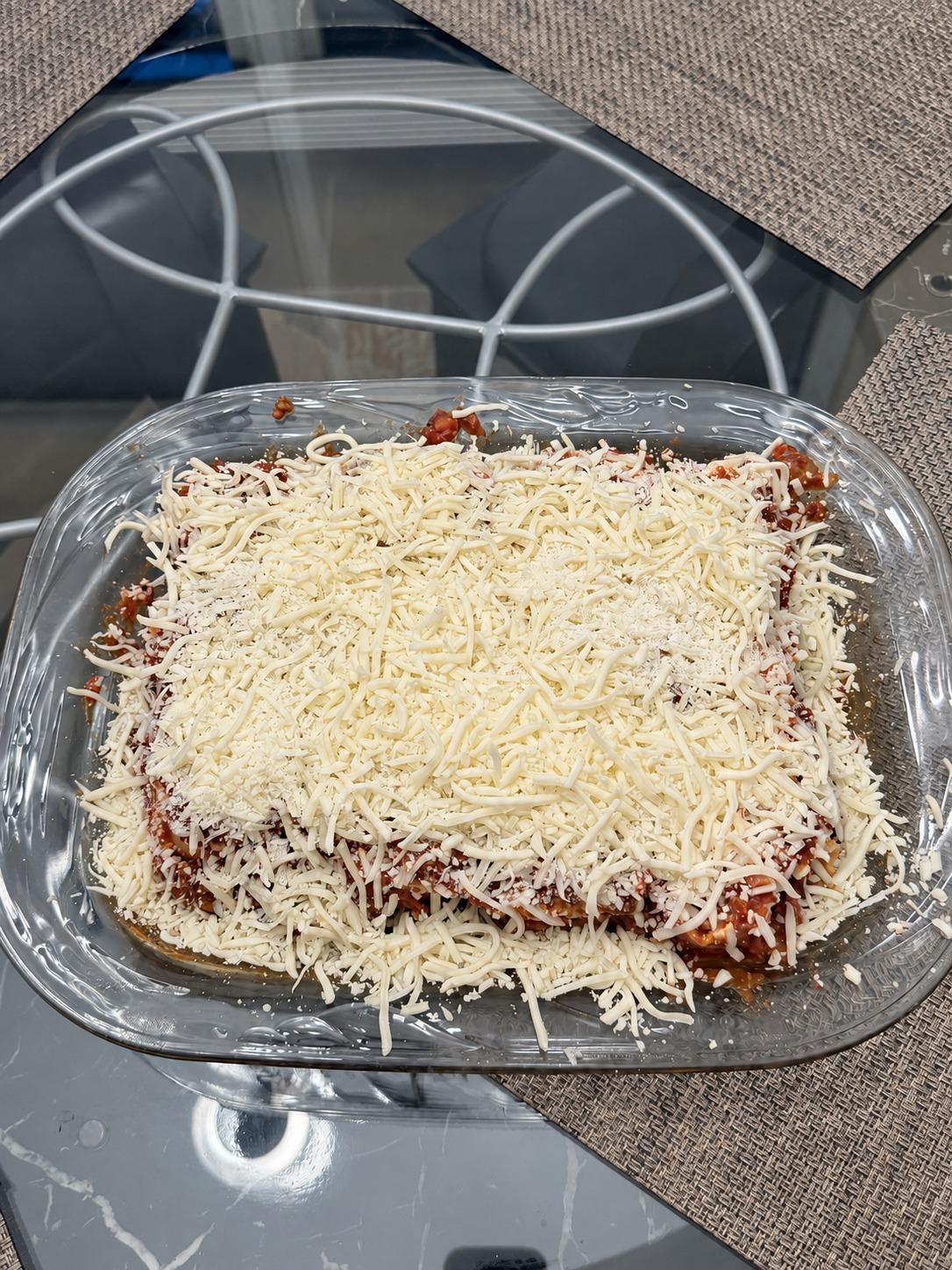 Cover with more shredded mozzarella and freshly grated Parmesan.